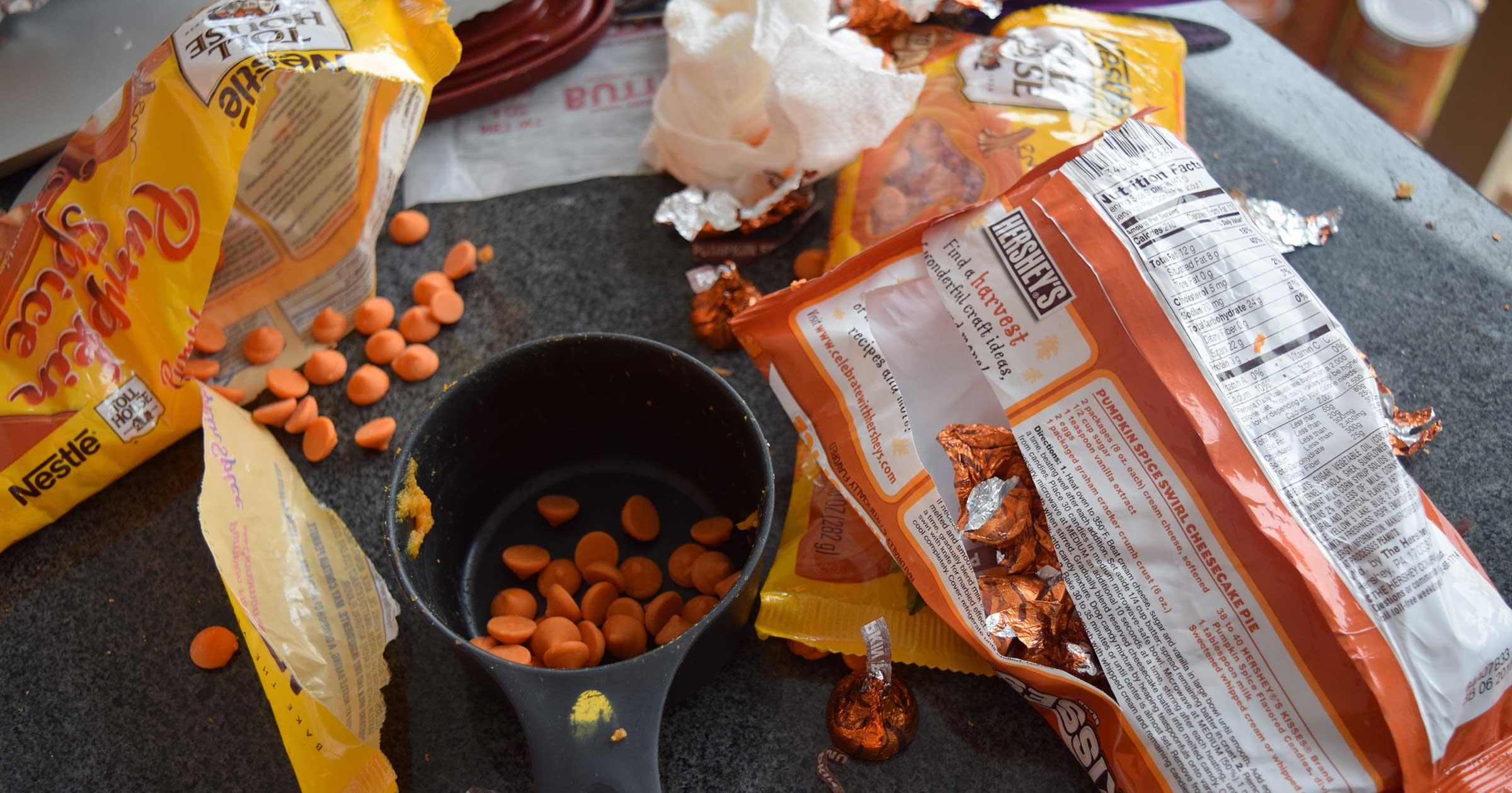 Assorted cake ingredients: pumpkin spice chocolate chips and pumpkin spice Kisses.